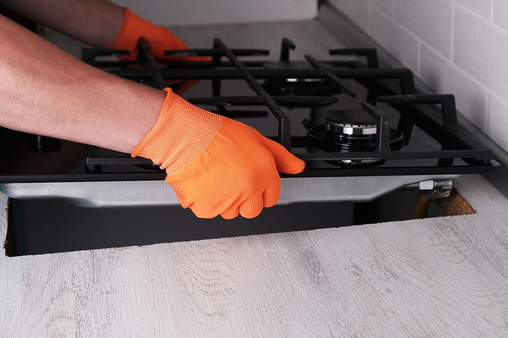 A new gas hob being fitted.