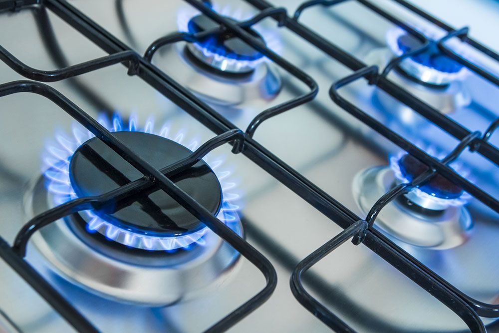 A set of blue gas flames on a cooker