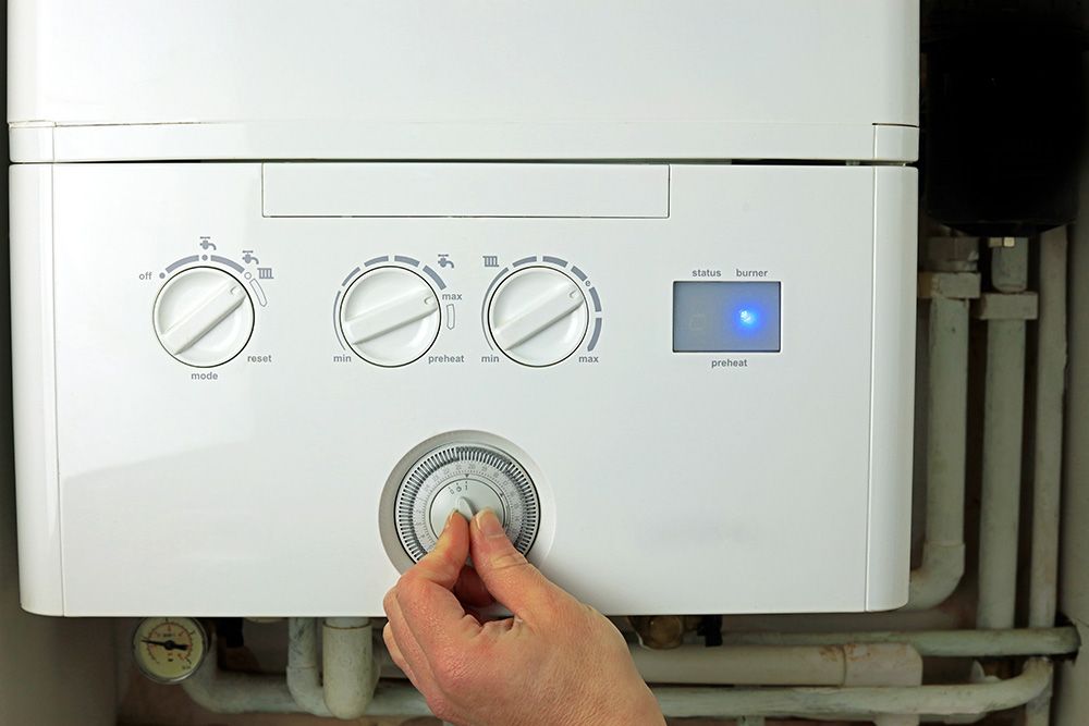 A boiler dial being adjusted